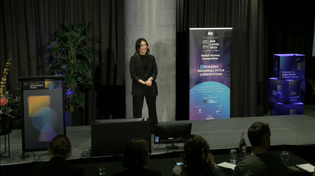 Betty Karikis representing Elli Cares on stage at the She Loves Tech Oceania Finals