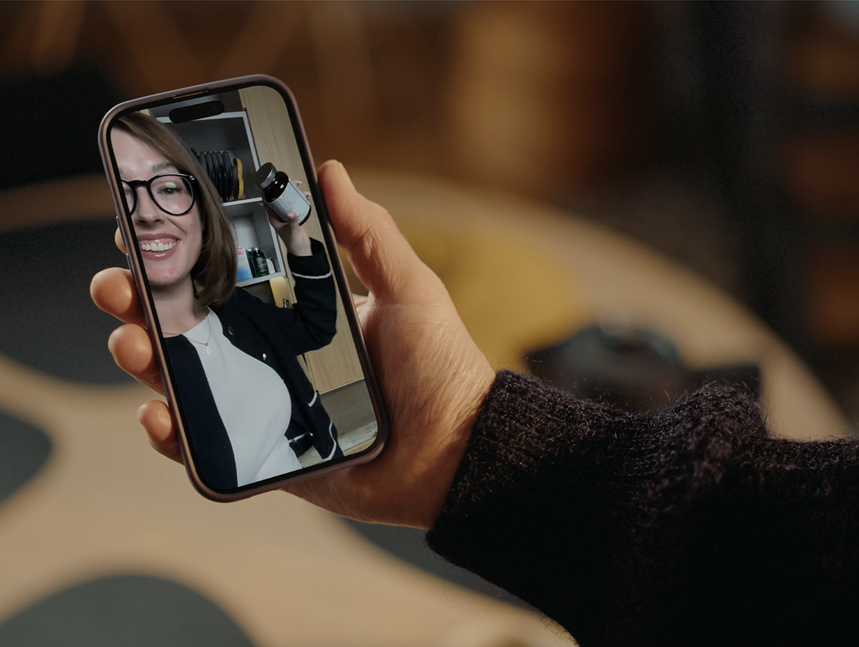 A mobile phone showing a video reminder on it.